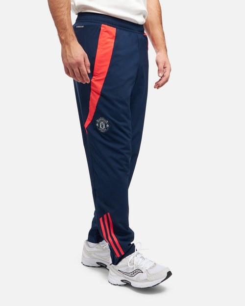 Pantaloni della tuta Manchester United 2024/2025 - Blu/Arancione - Footkorner